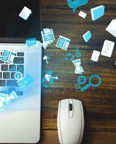 digital composite of mouse and laptop with communication graphics